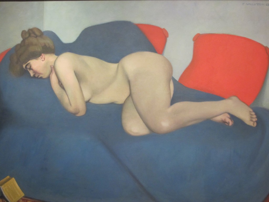 Seated nude woman brushing her hair